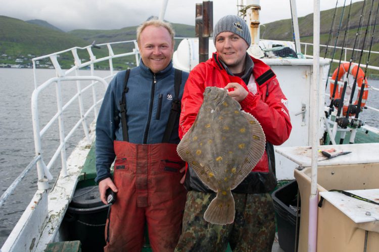 plaice fishing Faroe Islands Magni and Ally with a fish