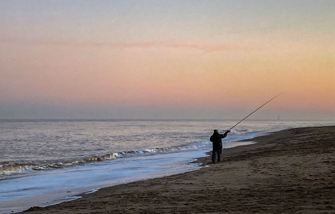 Tracey casting into a calm sea