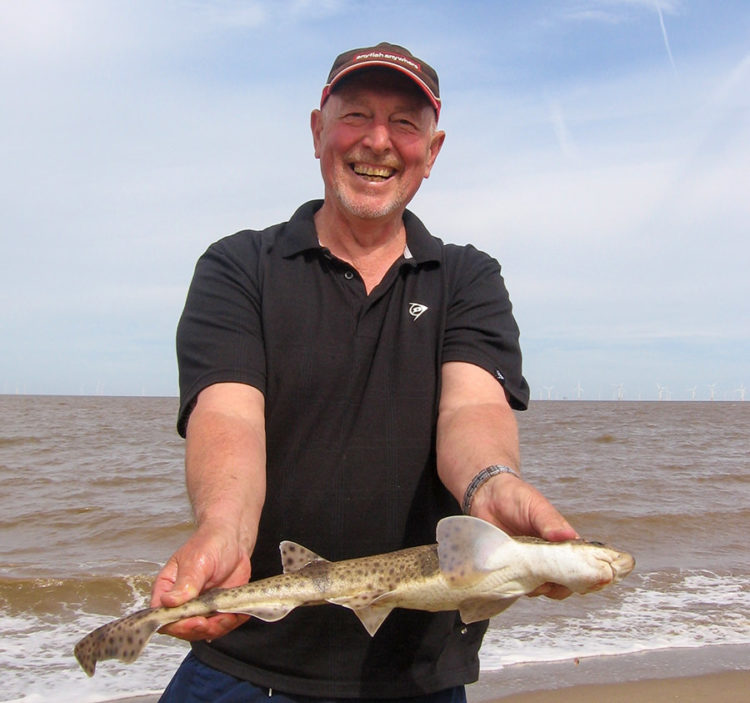 Match winner Garry Hutson with one of his five dogs